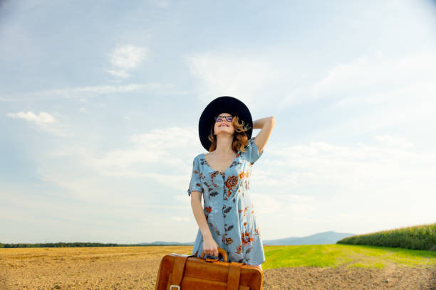 istock woman at countryside with suitcase 838561818