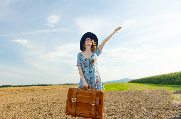istock woman at countryside with suitcase 838561890