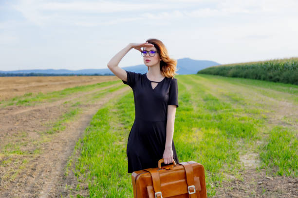 istock woman at countryside with suitcase 838562110