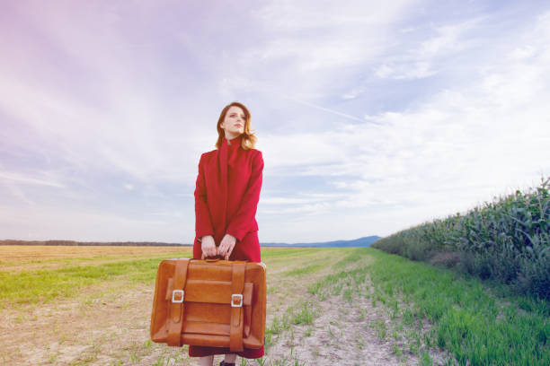 istock woman at countryside with suitcase 838562292