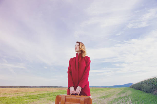 istock woman at countryside with suitcase 838562298