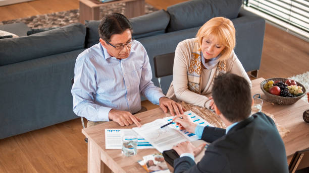 istock Banker discussing with senior couple 838566726