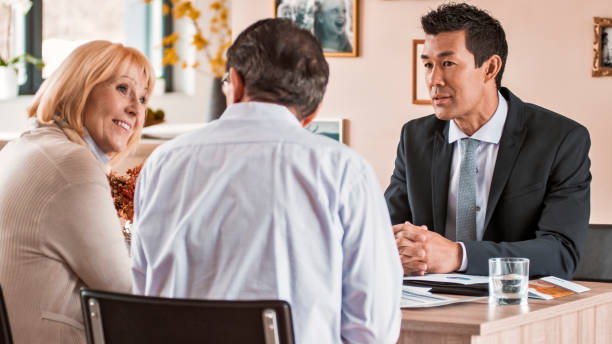 istock Banker discussing with senior couple 838566780