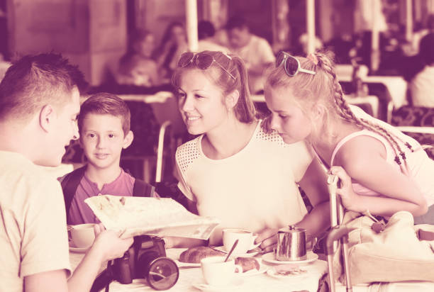 istock Cheerful parents with two kids relaxing in cafe 838570004