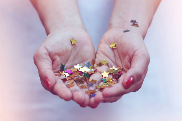 istock Girl holding gold star confetti 838574444