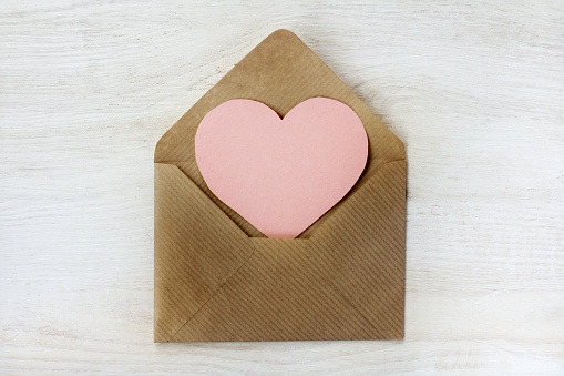 heart symbol is visible from an open, paper letter top view