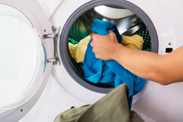 istock Person Putting Clothes In Washing Machine 838582528