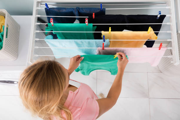 istock Woman Hanging Wet Cloth On Clothes Line 838583500