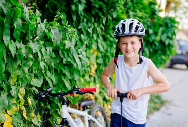 istock Boy child in white bicycle helmet inflating tire 838585656