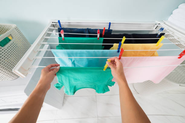 istock Person Hanging Wet Cloth On Clothes Line 838594354