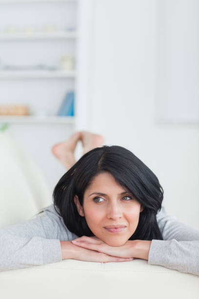 istock Woman relaxing on a couch holding her head with two hands 838724330