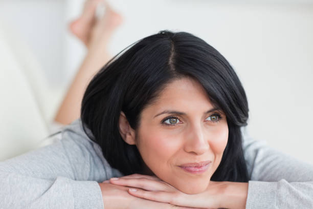 istock Smiling woman laying on a couch 838724412