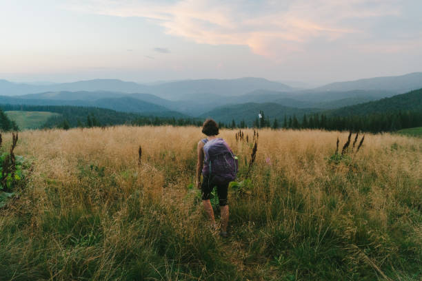 istock Woman with backpack hiking in mountains 838739772