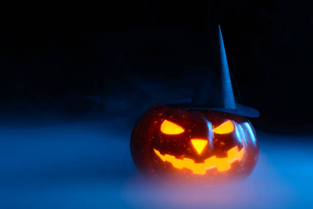 istock Pumpkin in witch hat in the fog 838740312