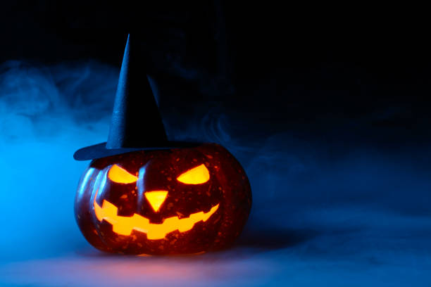 istock Pumpkin in witch hat in the fog 838740362