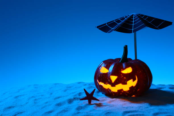 istock Creepy pumpkin on sandy beach 838740650