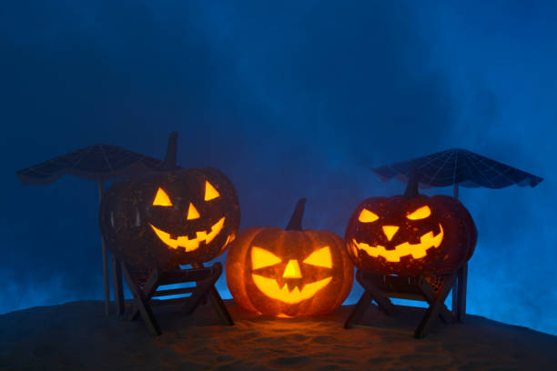 istock Carved pumpkins in composition on sand 838740790