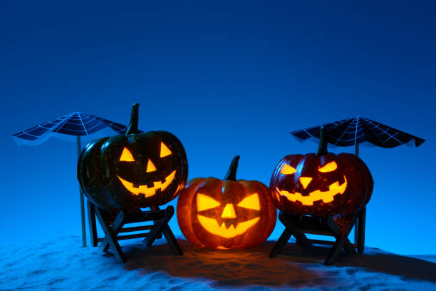 istock Carved pumpkins in composition on sand 838740800