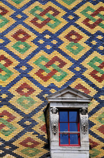 Slate roof in Lille (north of France) with a small red window