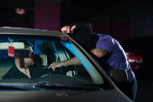 istock Aggressive thief pointing a gun at auto owner 838762770