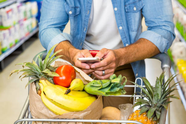 istock Man texting and grocery shopping 838771576