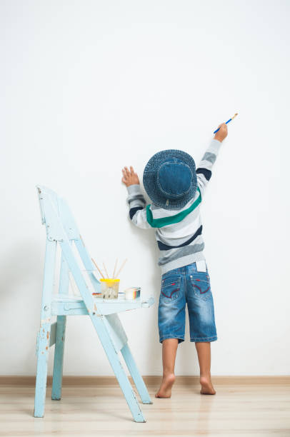 istock Happy child paints with paint. 838772300