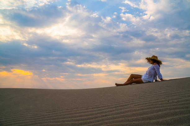 istock Woman sitting on the sand. 838780166