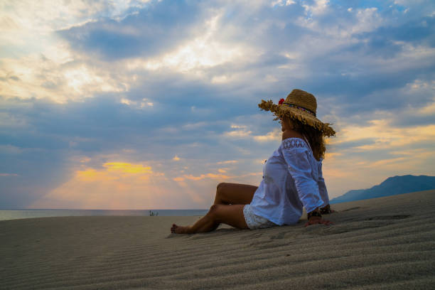 istock Woman sitting on the sand. 838796136