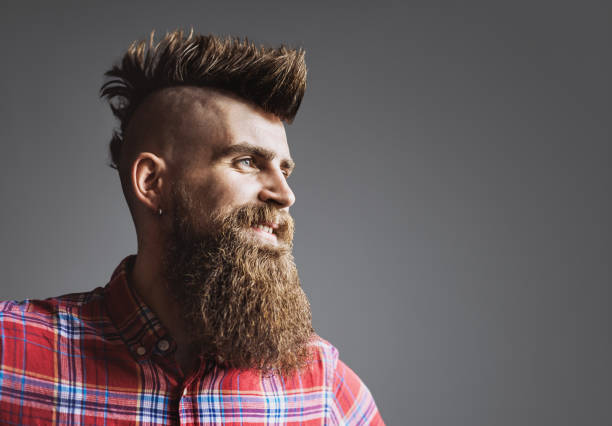 Young trendy man portrait Young punk rocker man smiling. Isolated on gray background man laughing hard stock pictures, royalty-free photos & images