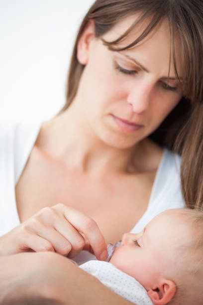 istock Serious woman giving a pacifier to her daughter 838825092