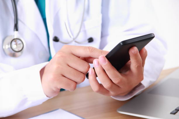 istock Female doctor using mobile phone 838829582