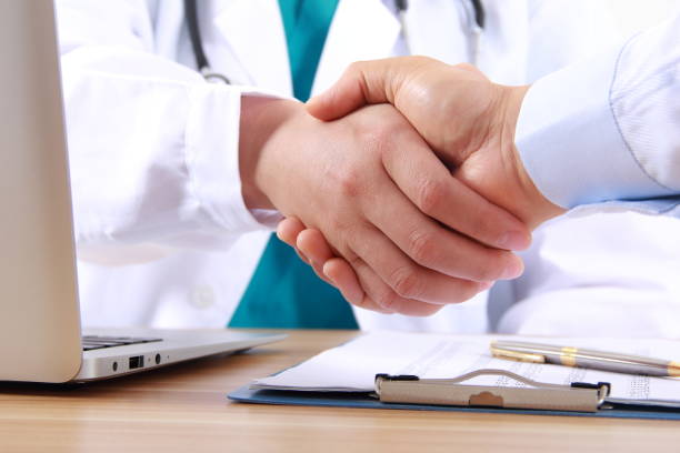 istock Doctor shakes hands with a patient 838830142