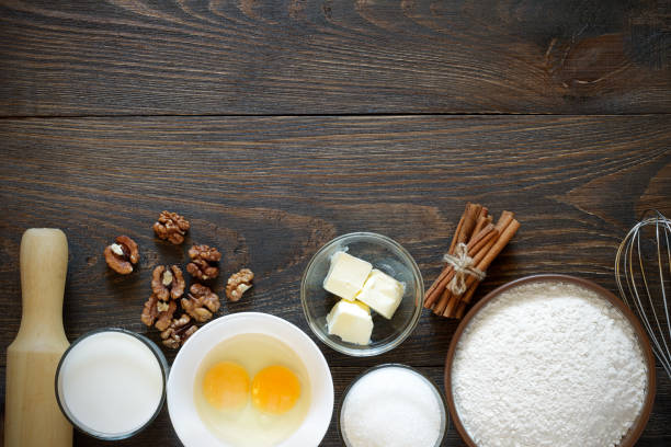 istock Ingredients for baking cake with walnuts on a dark wooden table. 838837018