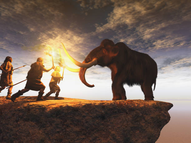 prehistoric men hunting a young mammoth - ancient world imagens e fotografias de stock