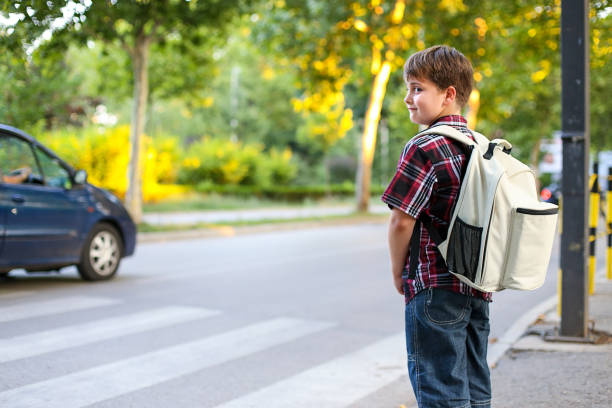 A young boy wearing a backpack climbs stairs, symbolizing back-to-school excitement and the start of a new educational journey.