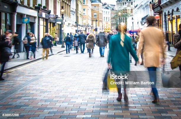 Shoppers Walking Down The High Street Holding Hands And Carrying Shopping Bags Stock Photo - Download Image Now