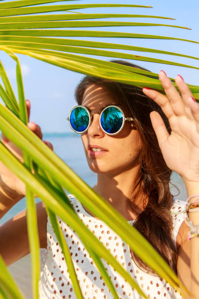 istock Sexy girl look thru palm leave. 838863868