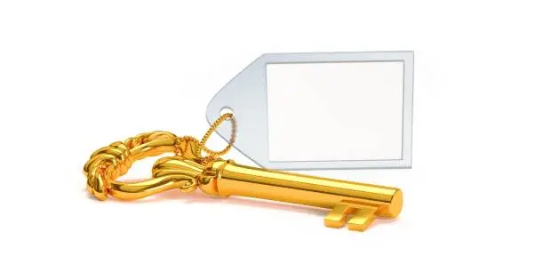 A Gold skeleton key with a blank label, resting, isolated on a white background