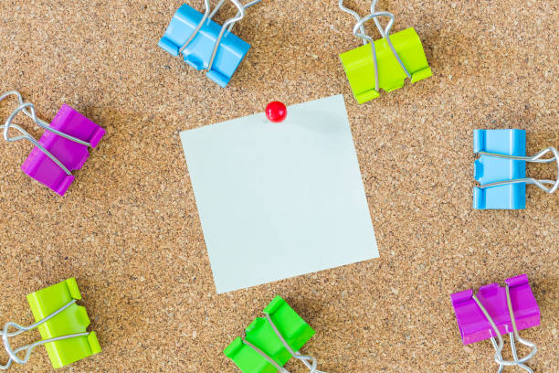 istock colorful binder clips on cork board with note 838867640