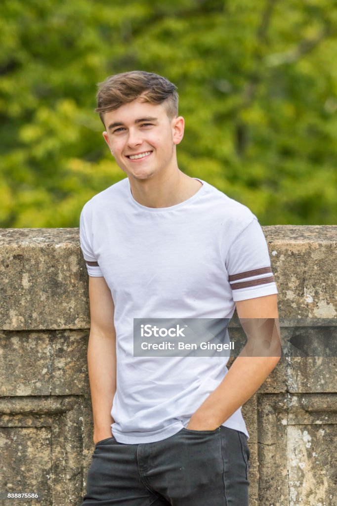 Teenage boy in a park on a warm summers day Boys Stock Photo