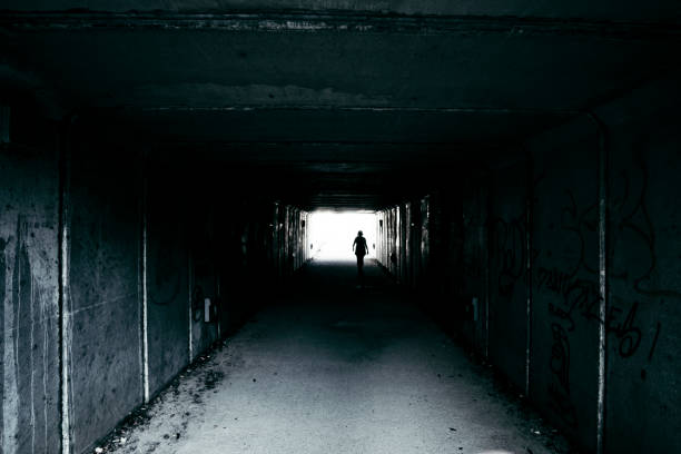 istock Black silhouette at the end of a dark tunnel footpath 838876006