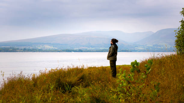 istock Hipster man standing by Loch Lomond, Scotland, UK 838879698