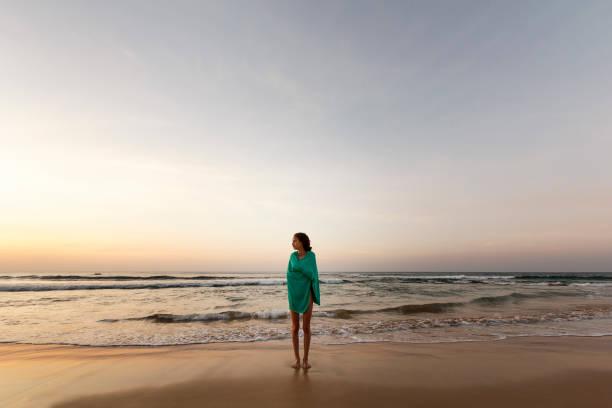 istock Girl wrapped on a towel watching the sea 838881442