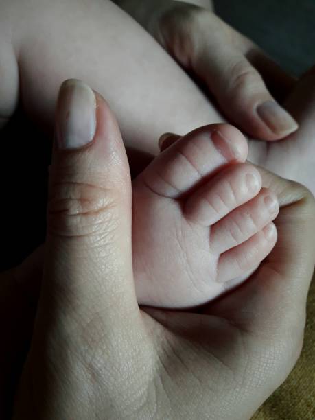 istock Mom holding her baby's feet 838881724