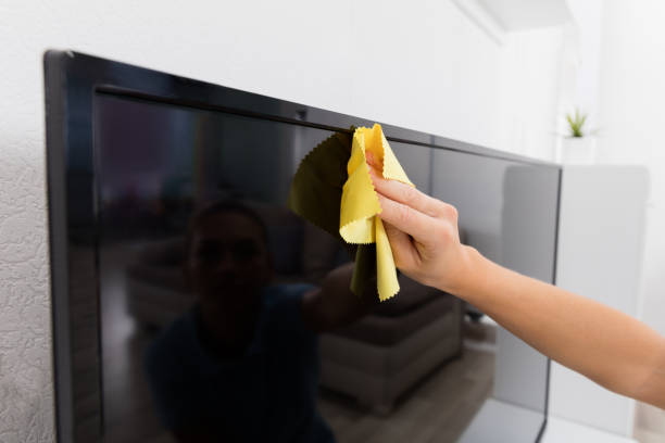 istock Woman Using Cloth To Clean The Television 838887914