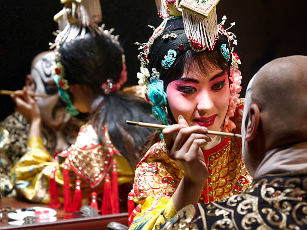Chinese opera singer applying makeup to male  chinese opera makeup stock pictures, royalty-free photos & images