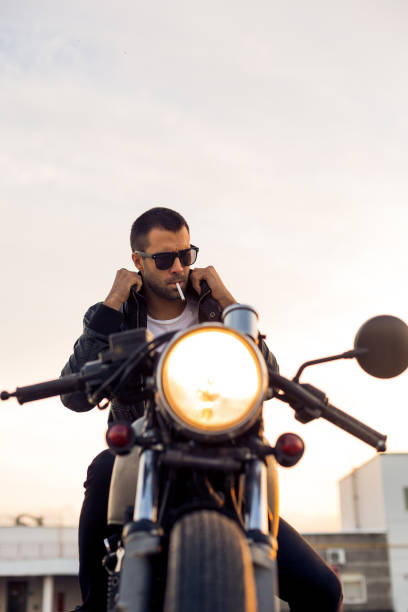 istock Brutal man sit on cafe racer custom motorbike. 838894212