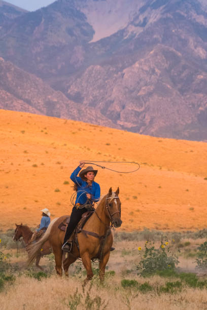 istock Cowgirl Spinning Her Lasso While Working On The Range 838894690