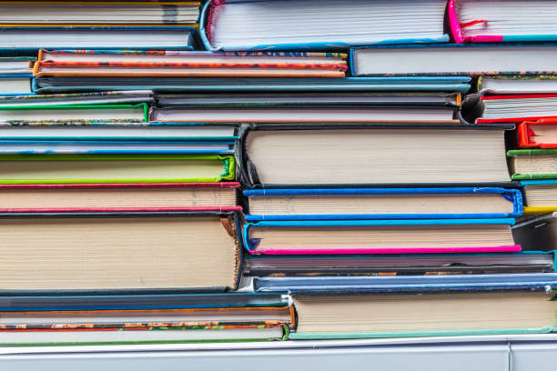 istock Stack of books on a shelf, multicolored book spines. 838895562