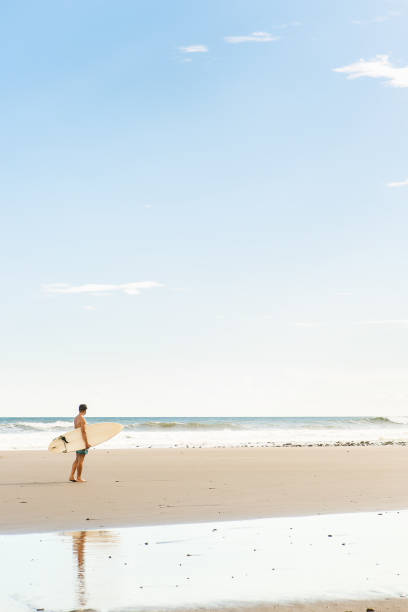 istock Handsome man with surfing board on spot. 838895614